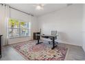 Bright home office with hardwood floors and large window at 7678 Notched Pine Bnd, Wesley Chapel, FL 33545