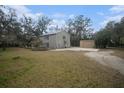 Two-story house with detached garage and yard at 8575 Carey Rd, Lithia, FL 33547