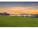 Spacious backyard with a lush lawn and waterfront access at 8839 W Millpoint Rd, Riverview, FL 33578