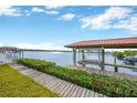 Waterfront dock featuring a boat lift and serene views at 8839 W Millpoint Rd, Riverview, FL 33578