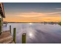Wooden dock extending over calm waters at sunset at 8839 W Millpoint Rd, Riverview, FL 33578