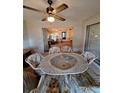 Bright sunroom with table and chairs, overlooking the living area at 1010 Bowsprit Ln # 0, Holiday, FL 34691