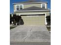 Two-story house with a light beige exterior and a two-car garage at 1112 Lake Shore Ranch Dr, Seffner, FL 33584