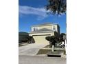 Two-story house with a light beige exterior and a two-car garage at 1112 Lake Shore Ranch Dr, Seffner, FL 33584