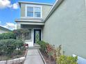 Inviting front entrance of home with beautiful decorative glass door and mature landscaping at 1112 Lake Shore Ranch Dr, Seffner, FL 33584