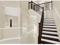 Elegant staircase with dark wood railings and white risers at 11120 Kempton Vista Dr, Riverview, FL 33579