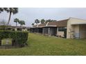 Condo building exterior showcasing multiple units and lawn at 11122 Pembridge Ct # 2, Port Richey, FL 34668