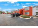 Red brick building exterior with parking and landscaping at 1290 83Rd N Ave # D, St Petersburg, FL 33702