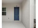 Contemporary dark blue front door with a simple design at 15171 Pomp Parkway, Weeki Wachee, FL 34614