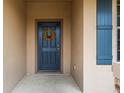 Dark blue front door with a fall-themed wreath at 15579 Stone House Dr, Brooksville, FL 34604