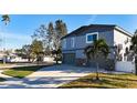 Two-story house with a large driveway and mature landscaping at 1600 Pennsylvania Ne Ave, St Petersburg, FL 33703