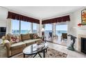 Living room with ocean view and balcony access at 17980 Gulf Blvd # 501, Redington Shores, FL 33708