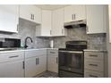 Modern kitchen with gray cabinets and marble countertops at 19029 Us Highway 19 N # 6-16, Clearwater, FL 33764