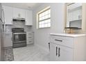 Updated kitchen featuring gray cabinets and marble floors at 19029 Us Highway 19 N # 6-16, Clearwater, FL 33764