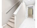 Interior view of carpeted staircase and hallway with light flooring at 2547 Lexington Oak Dr, Brandon, FL 33511