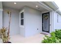 Front entry with black door and sidelights, welcoming porch at 2564 89Th Street E Cir, Palmetto, FL 34221