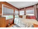 Cozy bedroom with a daybed and wood paneled walls at 2819 50Th S St, Gulfport, FL 33707