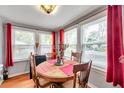 Small dining area with a round wooden table and red accents at 2819 50Th S St, Gulfport, FL 33707