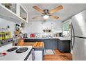 Small kitchen with white cabinets and dark countertops at 2819 50Th S St, Gulfport, FL 33707