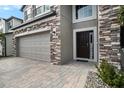 Dark brown front door with stone accents at 3071 Marine Grass Dr, Wimauma, FL 33598