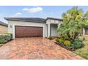 House exterior with brick driveway and palm trees at 31703 Cabana Rye Ave, San Antonio, FL 33576