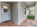 Light gray front door with wreath and brick walkway at 31703 Cabana Rye Ave, San Antonio, FL 33576