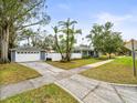 Home with attached garage and a spacious front yard at 320 N Madison Ave, Clearwater, FL 33755