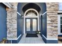 Inviting entryway features a double door with glass inserts and a stone accent wall at 4101 Concord Way, Plant City, FL 33566