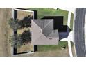 Top-down view of a house with a brown roof and a fenced backyard at 4179 Bramblewood Loop, Spring Hill, FL 34609