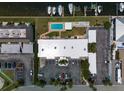 Top-down view of building, parking, and small pool at 423 S Paula Dr # 203, Dunedin, FL 34698