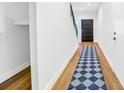 Hallway with hardwood floors and a stylish diamond patterned rug at 484 87Th Avenue North, St Petersburg, FL 33702