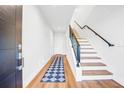 Light and bright entryway with hardwood floors and modern staircase at 484 87Th Avenue North, St Petersburg, FL 33702