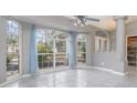 Dining room with large windows and light blue curtains at 5366 Hader Rd, North Port, FL 34288