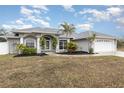 Two-story house with a landscaped yard and palm trees at 5366 Hader Rd, North Port, FL 34288