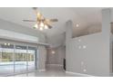 Living room with high ceilings, tile floors, and sliding glass doors to pool area at 5366 Hader Rd, North Port, FL 34288