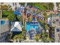 Aerial view of resort pool with surrounding lounge chairs and umbrellas at 5500 Gulf Blvd # 2240, St Pete Beach, FL 33706