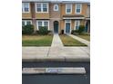 Two-story townhome with teal doors and walkway at 7041 Spotted Deer Pl, Riverview, FL 33569