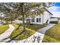 Landscaped backyard with a swing set and paved pathways at 7119 Peregrina Loop, Wesley Chapel, FL 33545