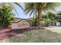 The Villas at Dove Palm community sign, with palm trees and landscaping at 820 Date Palm Ln, St Petersburg, FL 33707