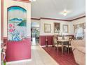 Dining room with a wooden table and chairs, and a painted accent wall at 9516 Cypress Harbor Dr, Gibsonton, FL 33534