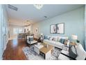 Bright living room with hardwood floors, white couch and modern decor at 10425 Westpark Preserve Blvd, Tampa, FL 33625