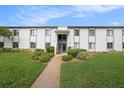 Condo building exterior, showing landscaping and walkway at 124 W Cypress Ct, Oldsmar, FL 34677