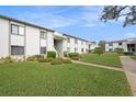 Condo building exterior showcasing landscaping and walkway at 124 W Cypress Ct, Oldsmar, FL 34677