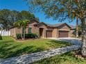 Lovely single-Gathering home with a spacious front yard, beautiful landscaping, and a convenient two-car garage at 1525 Banner Elk St, Valrico, FL 33594