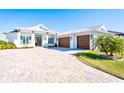 Stunning curb appeal featuring a two-car garage and paver driveway at 1818 4Th E St, Palmetto, FL 34221