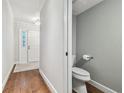 Clean and modern half bathroom with a pedestal sink and toilet at 2519 Crowder Ln, Tampa, FL 33629