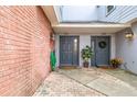 Shared entryway with gray doors and brick exterior walls at 2519 Crowder Ln, Tampa, FL 33629