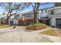 Gray townhome with double garage and manicured landscaping at 2519 Crowder Ln, Tampa, FL 33629