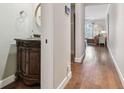 Bright hallway with hardwood floors, a half bathroom, and views into the living area at 2519 Crowder Ln, Tampa, FL 33629