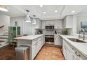 Modern kitchen featuring white shaker cabinets, quartz countertops, and stainless steel appliances at 2519 Crowder Ln, Tampa, FL 33629